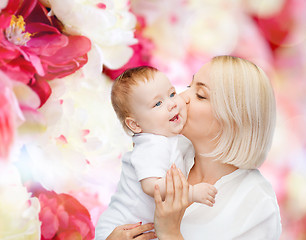 Image showing happy mother kissing smiling baby