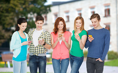 Image showing smiling students with smartphones