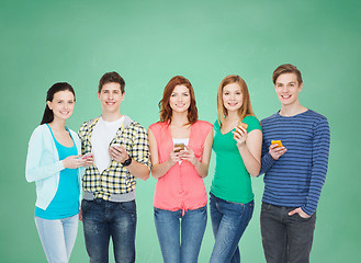 Image showing smiling students with smartphones