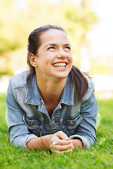 Image showing smiling young girl lying on grass