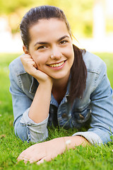 Image showing smiling young girl lying on grass