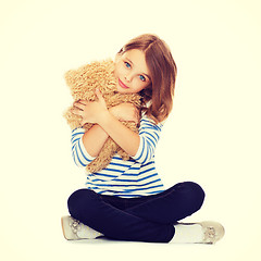 Image showing cute little girl hugging teddy bear