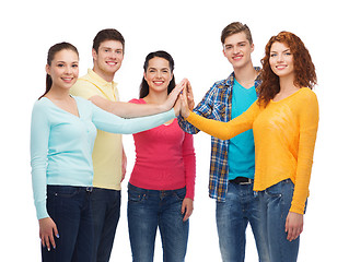 Image showing smiling teenagers making high five