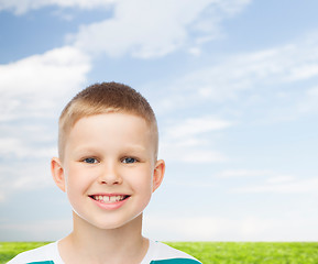 Image showing smiling little boy over natural background