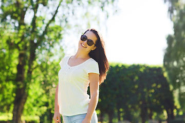 Image showing smiling young woman with sunglasses in park