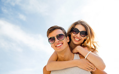 Image showing smiling couple having fun over sky background