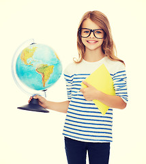 Image showing smiling child with globe, notebook and eyeglasses