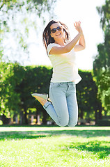 Image showing smiling young woman with sunglasses in park