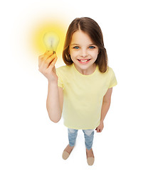 Image showing smiling little girl holding light bulb