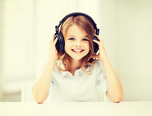 Image showing little girl with headphones at home