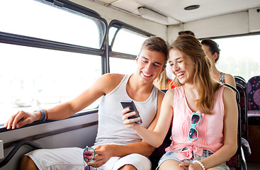 Image showing smiling couple with smartphone making selfie