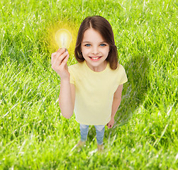 Image showing smiling little girl holding light bulb