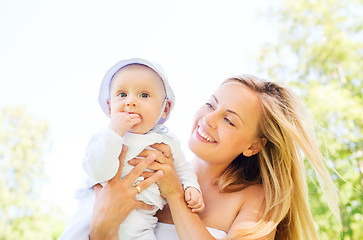 Image showing happy mother with little baby outdoors