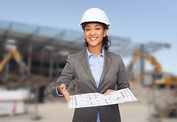 Image showing businesswoman in white helmet with blueprint