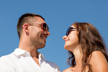 Image showing smiling couple over blue sky background