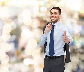 Image showing smiling young businessman showing thumbs up