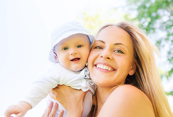 Image showing happy mother with little baby outdoors