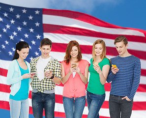 Image showing smiling students with smartphones