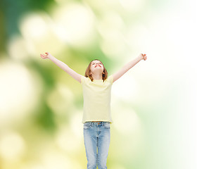 Image showing smiling teenage girl with raised hands