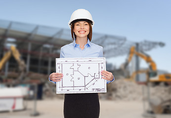 Image showing businesswoman in white helmet with blueprint