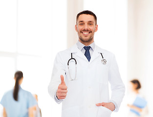 Image showing smiling doctor with stethoscope showing thumbs up