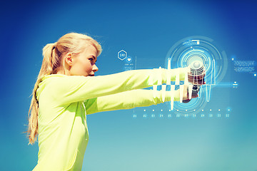 Image showing sporty woman with light dumbbells outdoors