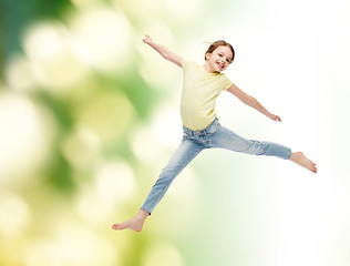 Image showing smiling little girl jumping