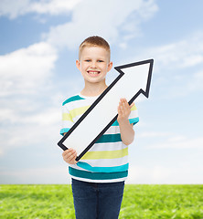 Image showing smiling little boy with blank arrow pointing right