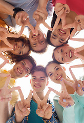 Image showing group of smiling teenagers showing victory sign