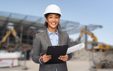 Image showing smiling architect in helmet with blueprint