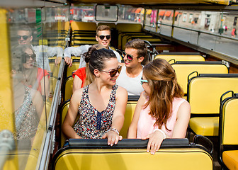 Image showing group of smiling friends traveling by tour bus