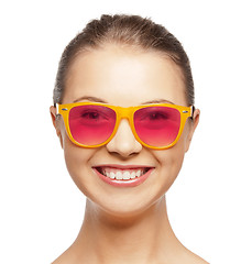 Image showing smiling teenage girl in pink sunglasses