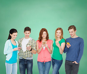 Image showing smiling students with smartphones