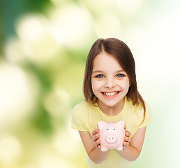 Image showing beautiful little girl with piggy bank