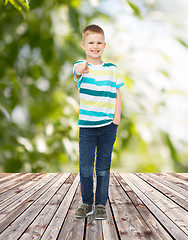 Image showing smiling little boy pointing finger at you
