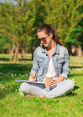 Image showing smiling young girl with notebook and coffee cup