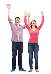Image showing smiling teenagers with raised hands