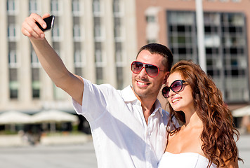 Image showing smiling couple in city