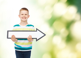 Image showing smiling little boy with blank arrow pointing right