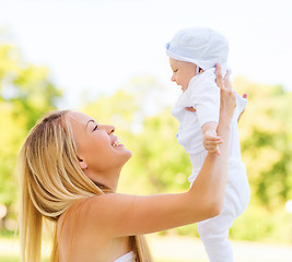 Image showing happy mother with little baby in park