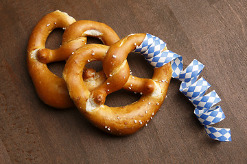 Image showing Two typical bavarian pretzel with white and blue streamer