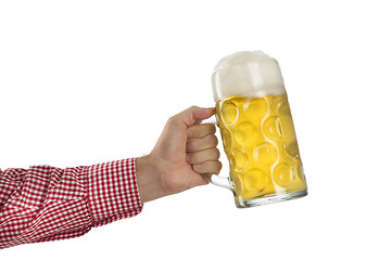 Image showing Man in traditional Bavarian shirt holds mug of beer