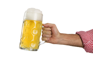 Image showing Man in traditional Bavarian shirt holds mug of beer