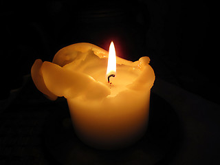 Image showing Candle burning in the dark