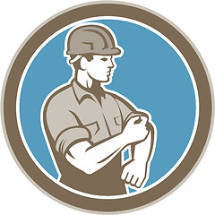 Image showing Construction Worker Rolling Up Sleeve Circle Retro