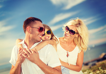 Image showing happy family in sunglasses having fun outdoors