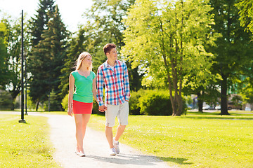 Image showing smiling couple walking in park