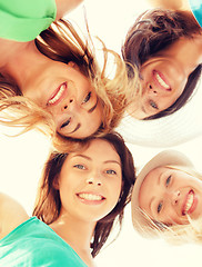 Image showing faces of girls looking down and smiling