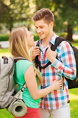 Image showing smiling couple with backpacks in nature