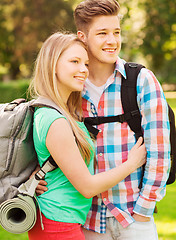 Image showing smiling couple with backpacks in nature